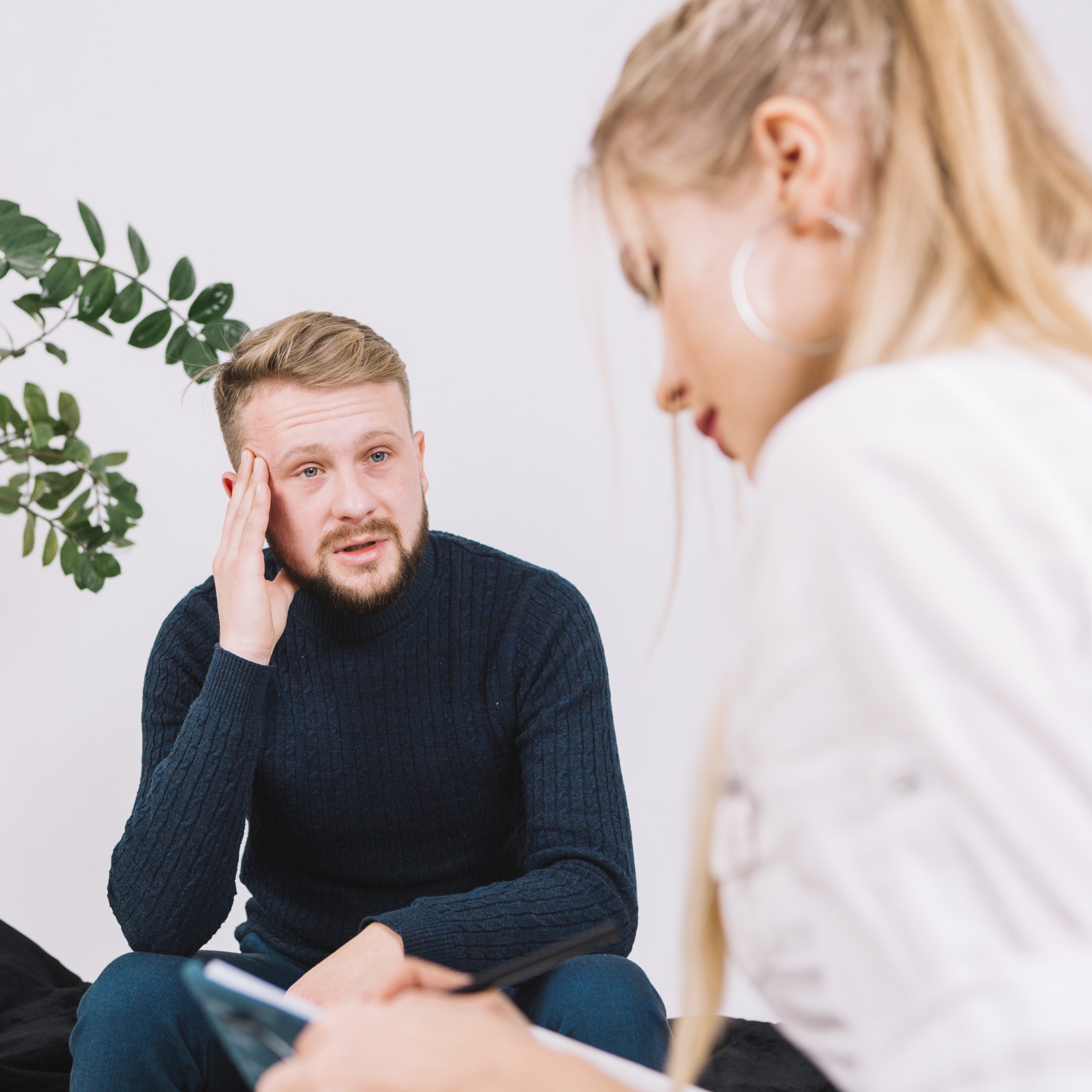 portrait-of-depressed-male-patient-talking-with-female-psychologist